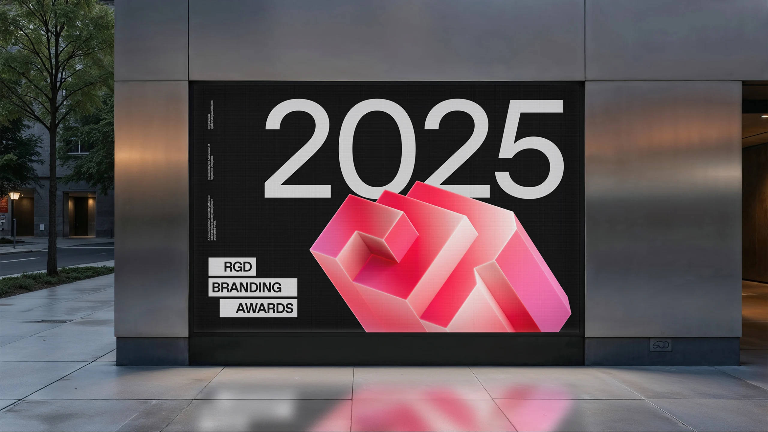 Digital billboard mockup featuring a massive 3D ruby "R" logo and white "2025" typography against a black grid background.