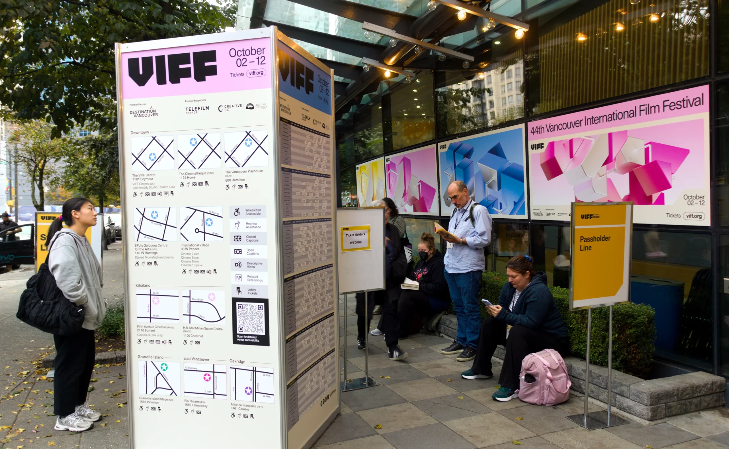 Outdoor festival hub signage with street maps and 2025 campaign branding for Vancouver International Film Festival.