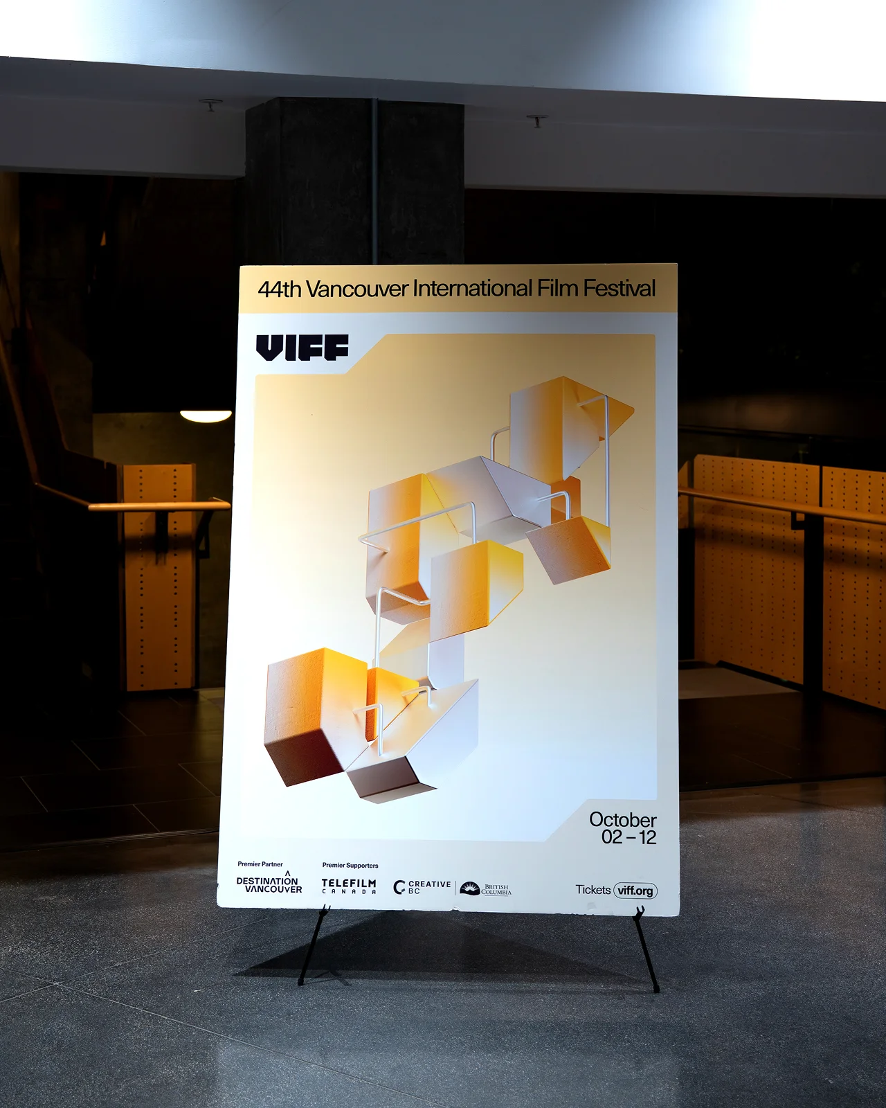 Large yellow 3D campaign poster for the Vancouver International Film Festival 2025 displayed at an outdoor venue.