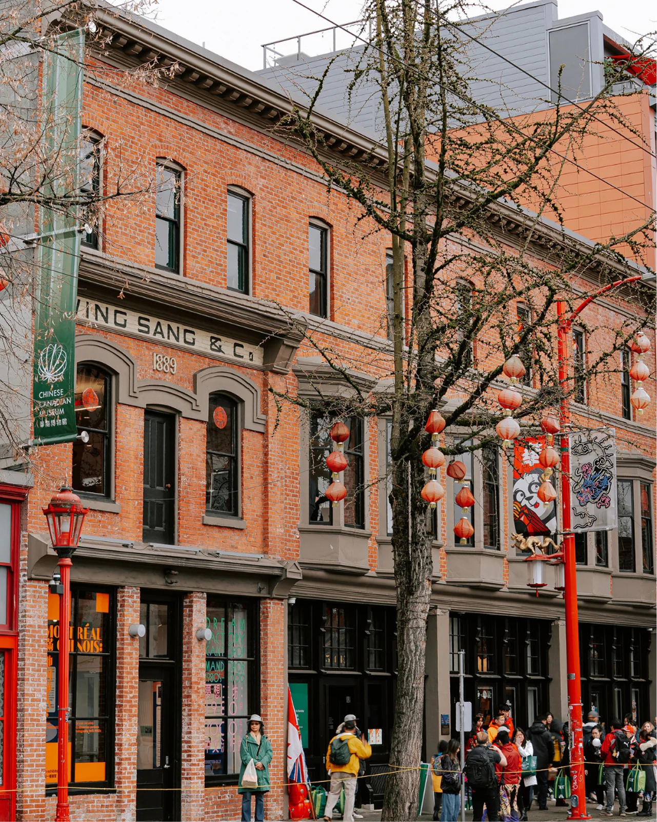 The historic red brick Wing Sang building in Vancouver’s Chinatown, featuring heritage architecture and 1889 Trading Co. branding.